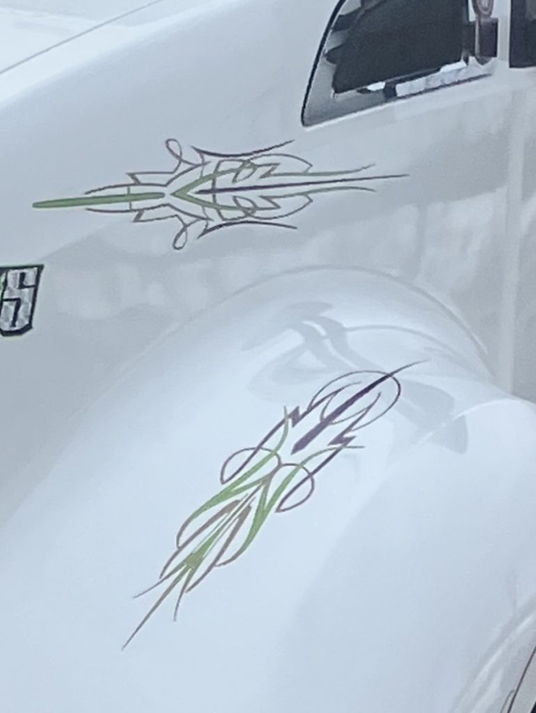 Custom hand lettering and linework on a truck